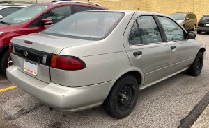 1996_Nissan_Sentra_XE_in_Platinum_Gold_Metallic_rear_right_05-28-2022.jpg