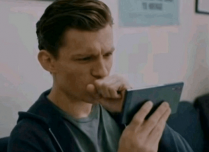 tom-holland-tom-hollond-looking-on-phone.png